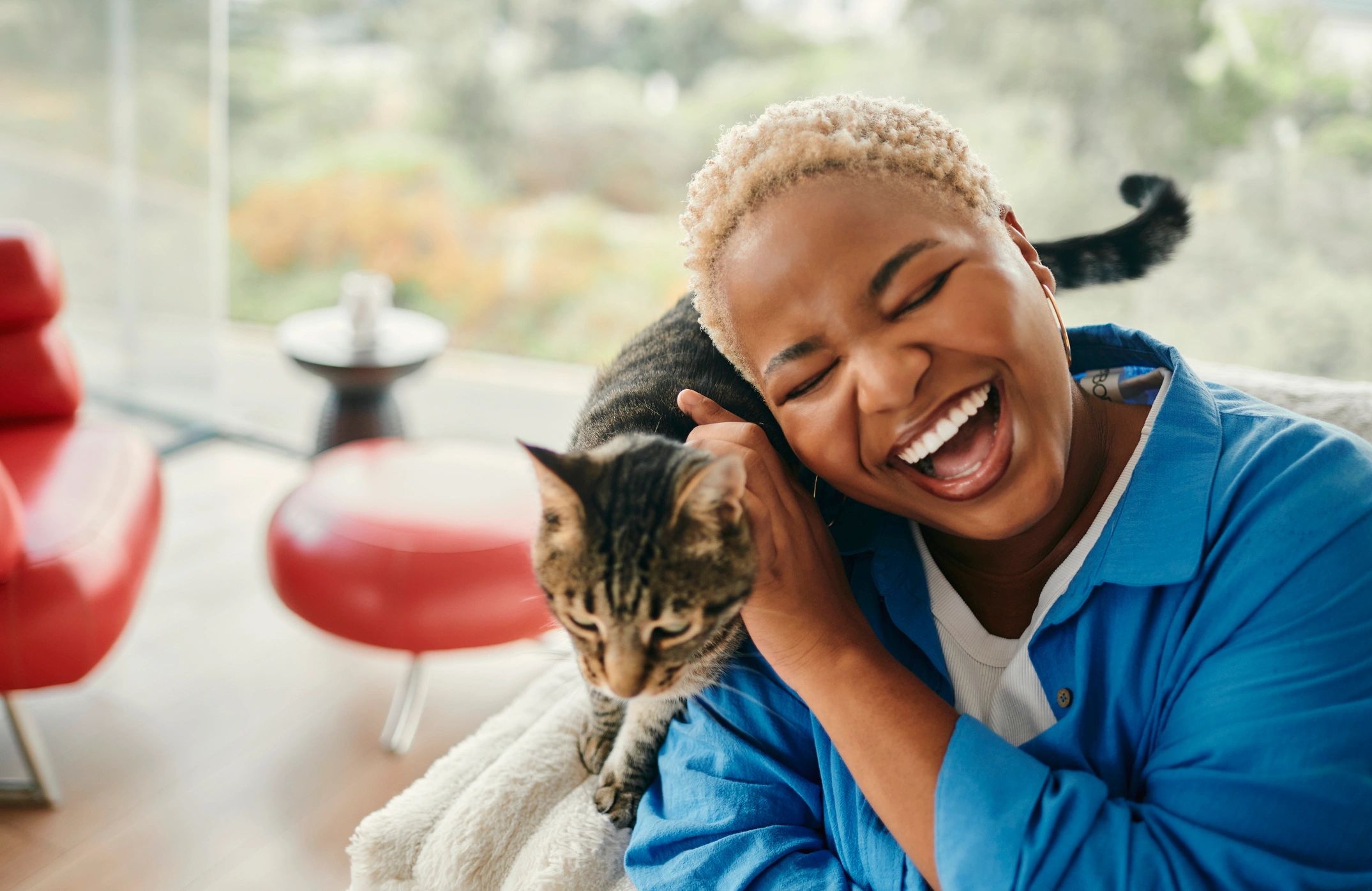 Cat owner holding a cat indoors